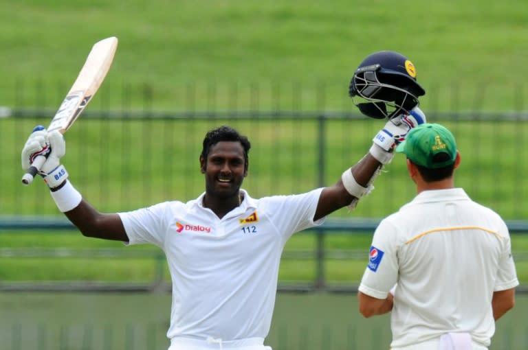 Sri Lankan captain Angelo Mathews celebrates reaching his century during the fourth day of the third and final Test against Pakistan in Pallekele on July 6, 2015