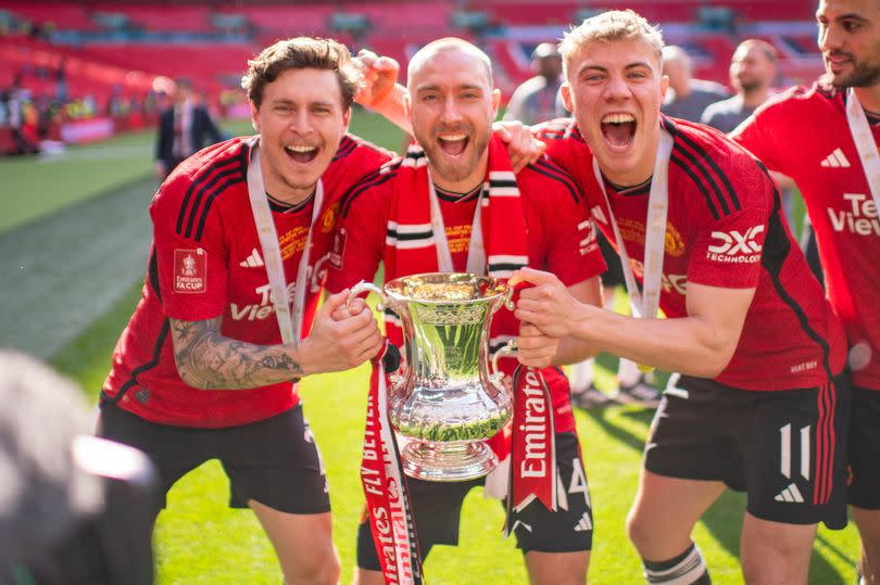 Victor Lindelof, Christian Eriksen  and Rasmus Hojlund of Manchester United celebrates with the Emirates FA Cup trophy after winning the Emirates FA Cup Final match between Manchester City and Manchester United at Wembley Stadium on May 25, 2024