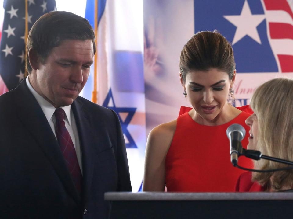 Gov. Ron DeSantis, left, and his wife Casey, center, share a prayer with Pam Olsen during national prayer day Thursday May 2, 2019, in Tallahassee, Florida.