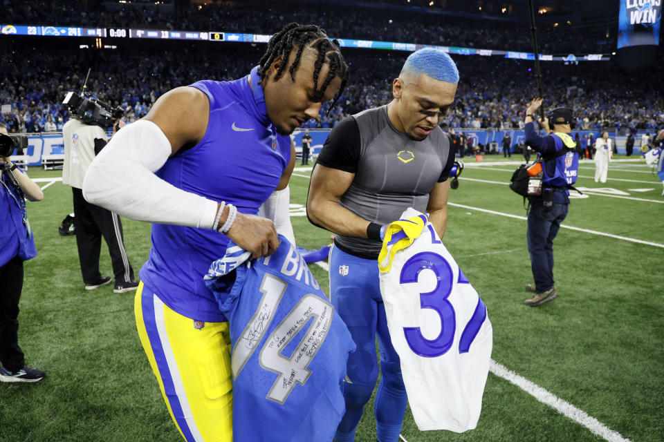 Detroit Lions wide receiver Amon-Ra St. Brown, right, and Los Angeles Rams safety Quentin Lake swap jerseys after the second half of an NFL wild-card playoff football game, Sunday, Jan. 14, 2024, in Detroit. (AP Photo/Duane Burleson)
