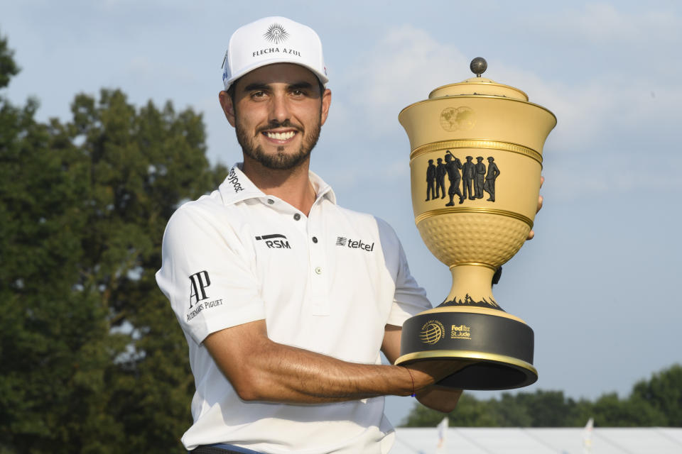 Abraham Ancer holds the trophy after winning the World Golf Championship-FedEx St. Jude Invitational tournament, Sunday, Aug. 8, 2021, in Memphis, Tenn. (AP Photo/John Amis)