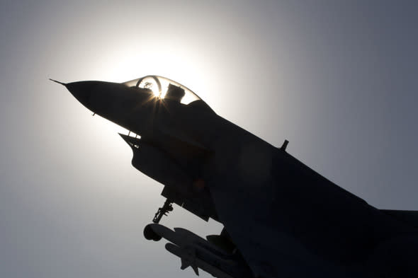 The replica of a Chinese made fighter jet is silhouetted against the sun in Beijing, China, Wednesday, Nov. 27, 2013. China said Wednesday it had monitored two unarmed U.S. bombers that flew over the East China Sea in defiance of Beijing's declaration it was exercising greater military control over the area. (AP Photo/Ng Han Guan)