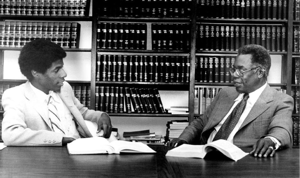 Nathaniel Colley Jr. discusses a case with his father Nathaniel Colley Sr. in the library of their office in October 1981.