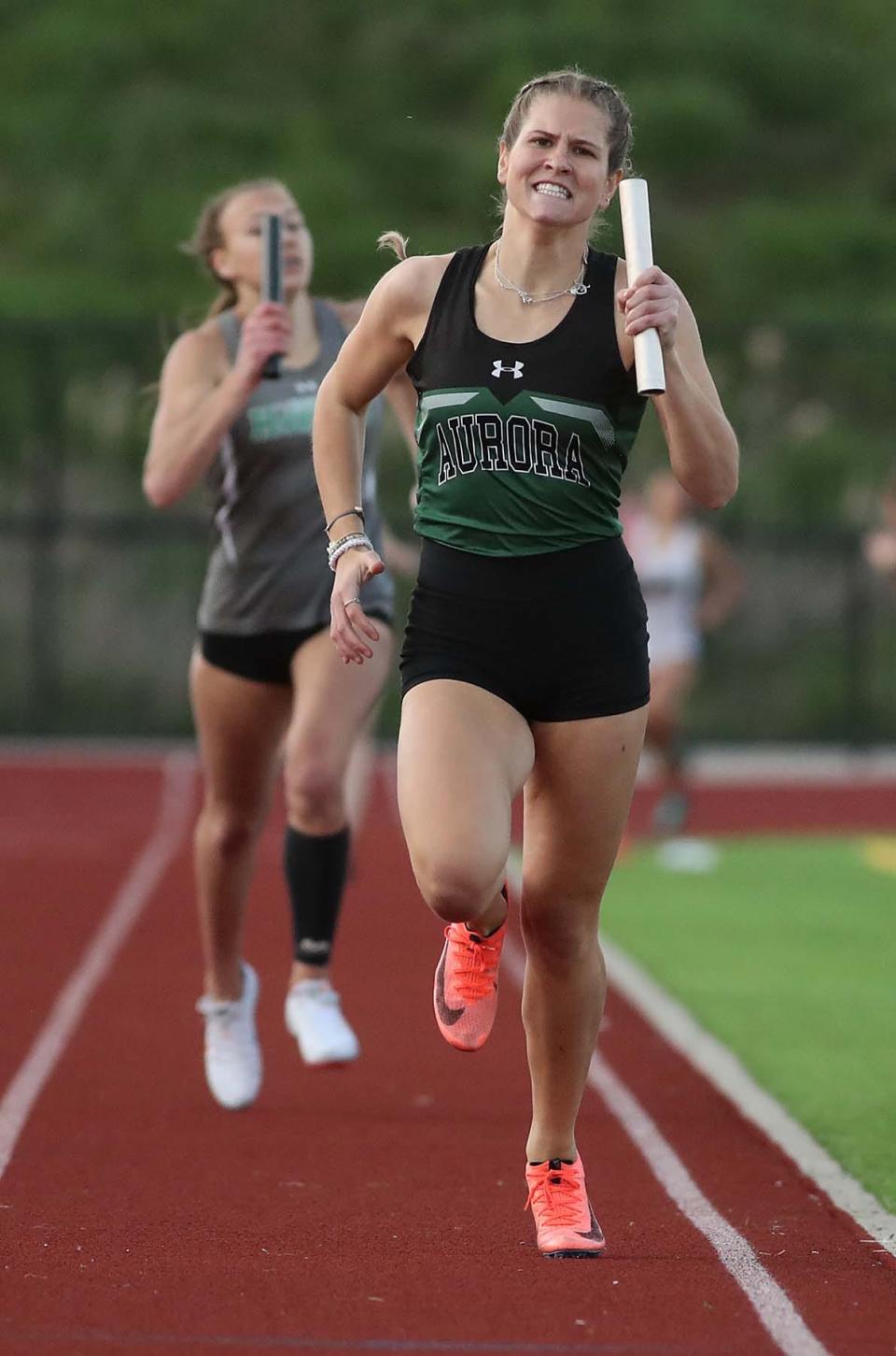 Lauren Tincher of Aurora anchors the team of Grace Barto, Alyssa Marotta and Hannah Rogge to a first place finish with a time of 4:08.56 in the 4 x 400 meter relay to clinch team victory for Aurora during the Suburban League American Conference Meet at Tallmadge High School in Tallmadge on Tuesday. 