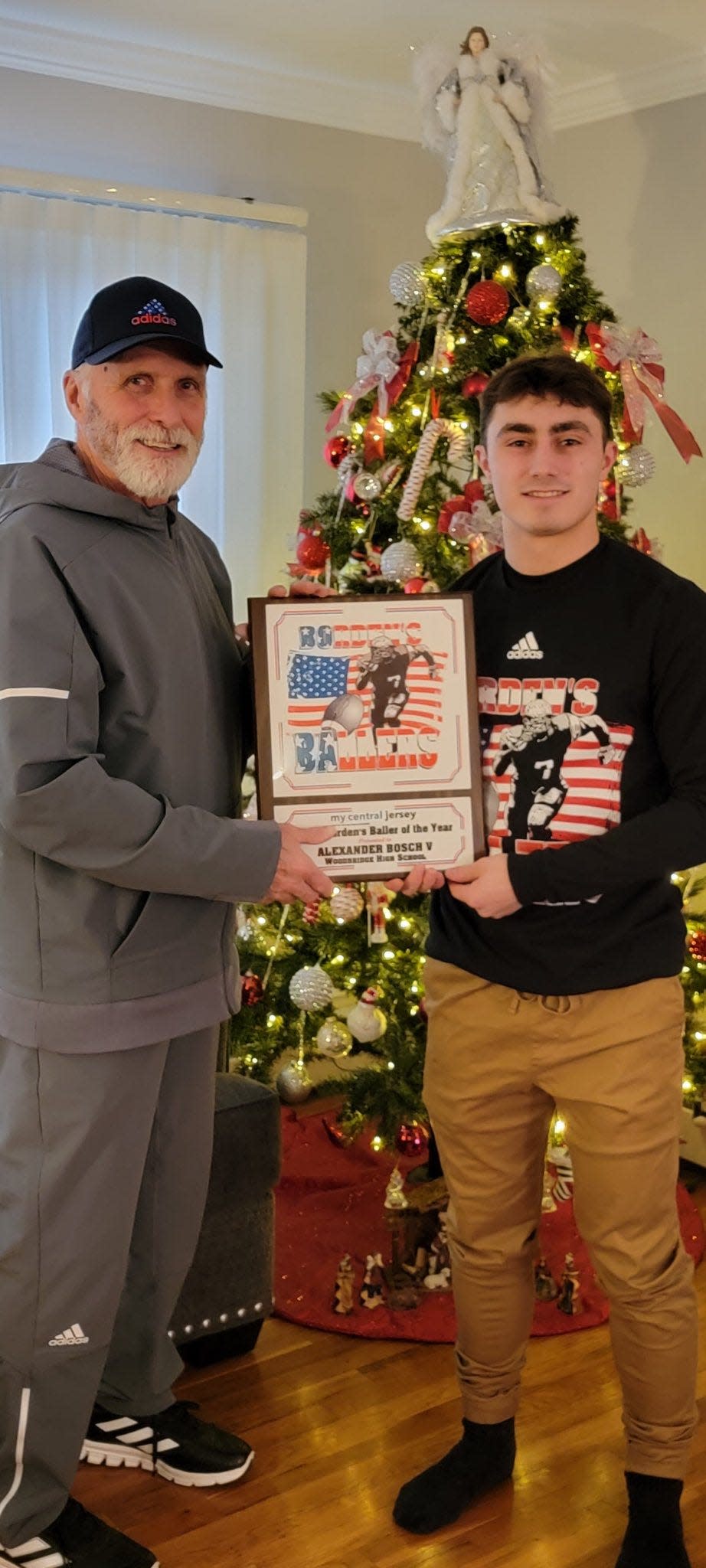 Marcus Borden presents AJ Bosch with the 2022 Borden’s Baller of the Year award