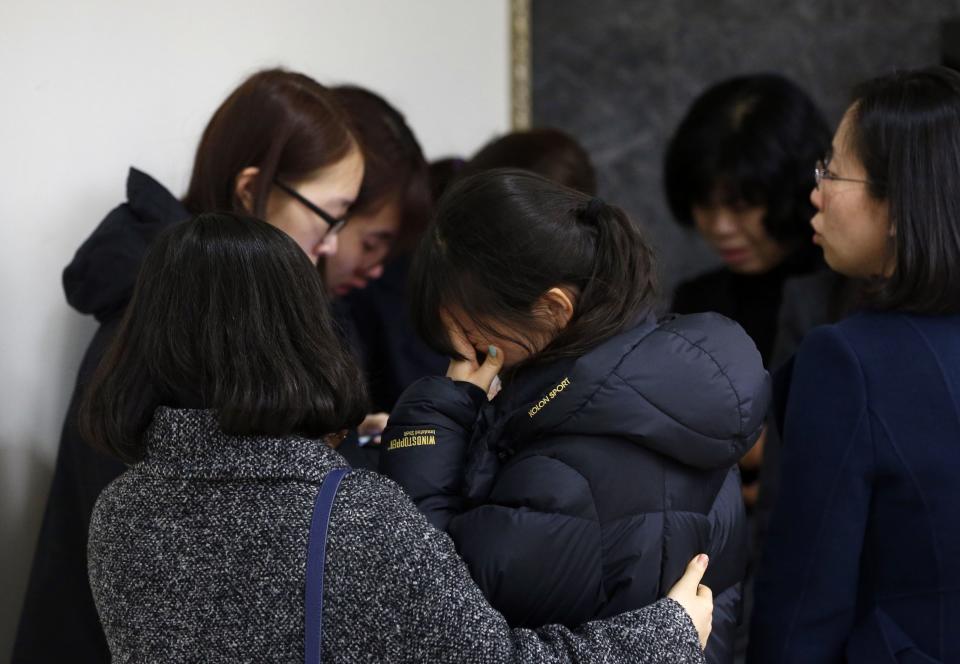 Friends of victims who were killed when a resort building collapsed, react after they paid their tribute outside a group memorial altar in Gyeongju