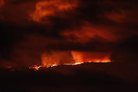 A river of lava flows down from Mauna Loa, Monday, Nov. 28, 2022, near Hilo, Hawaii. Mauna Loa, the world's largest active volcano erupted Monday for the first time in 38 years. (AP Photo/Marco Garcia)