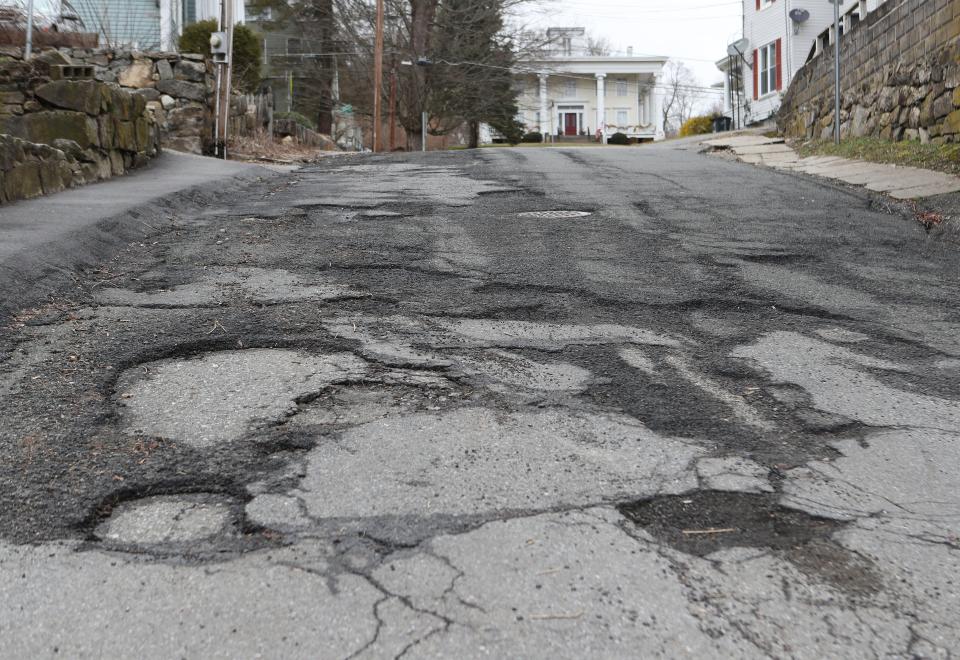 Potholes along Wilkes Street in the village of Brewster March 7, 2024.