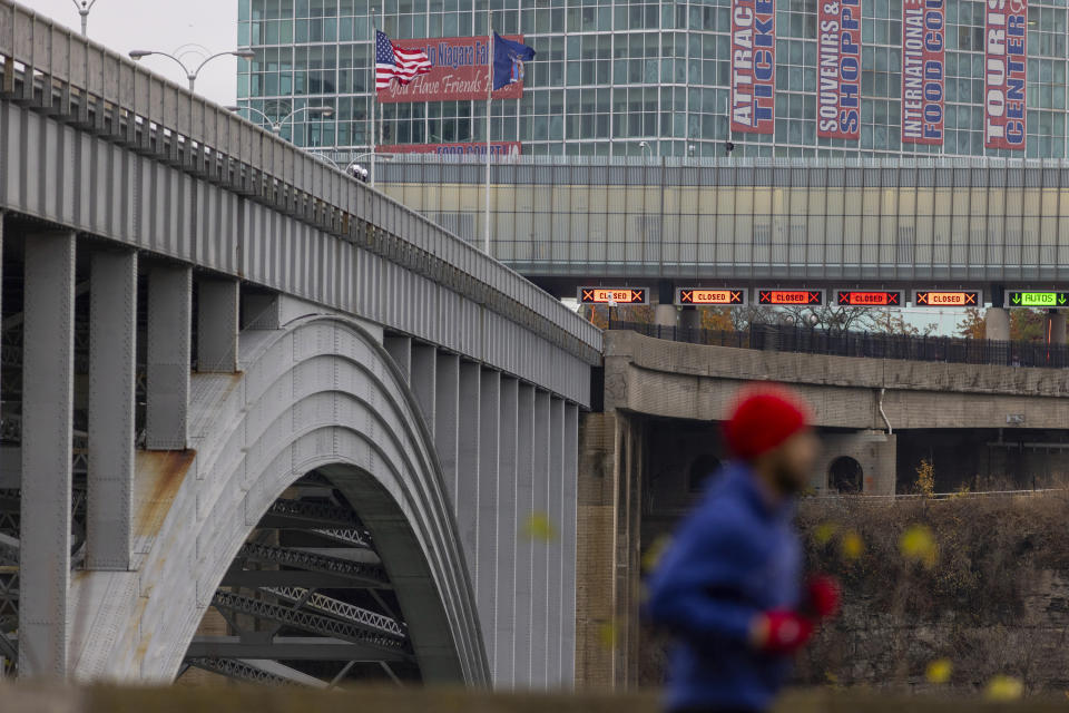 Several lanes of the Rainbow Bridge border crossing between the U.S. and Canada are closed, Wednesday, Nov. 22, 2023, in Niagara Falls, Ontario, after a vehicle exploded at a checkpoint on the American side of the bridge (Carlos Osorio/The Canadian Press via AP)