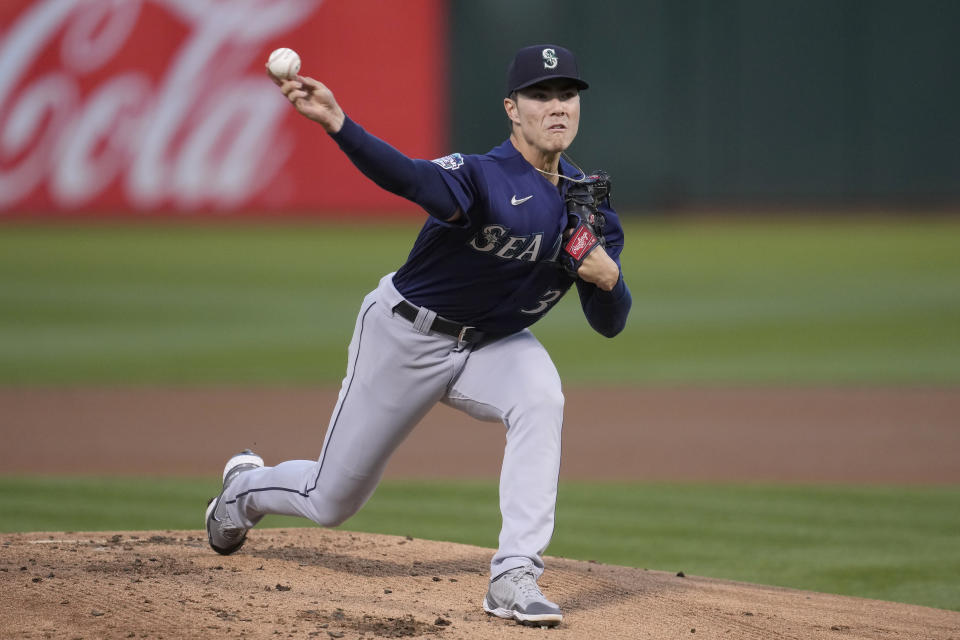 Seattle Mariners pitcher Bryan Woo works against the Oakland Athletics during the first inning of a baseball game in Oakland, Calif., Monday, Sept. 18, 2023. (AP Photo/Jeff Chiu)