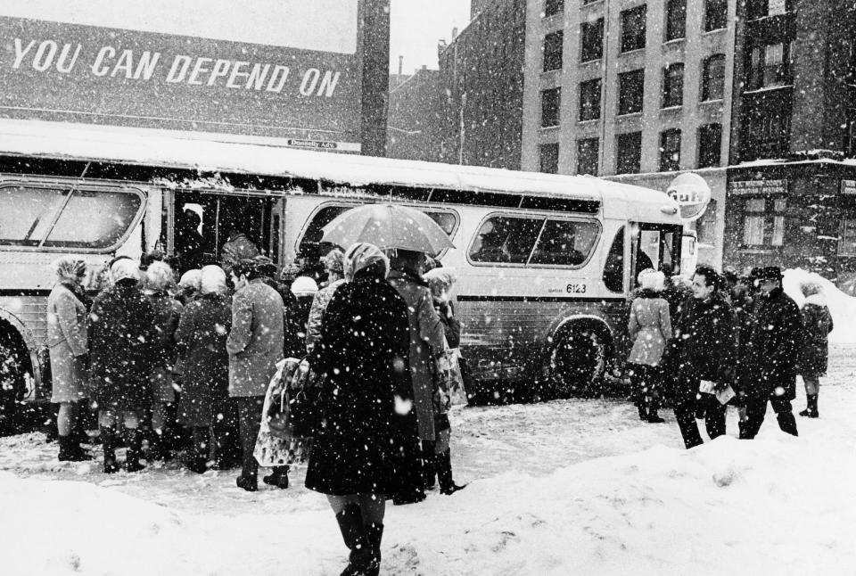 A crowd boards a bus in the snow on Summer Street in Boston on March 3, 1969, after the third major snow storm of the year. The four-day storm, between Feb. 24 and 28, left 26.3 inches of snow in the city.