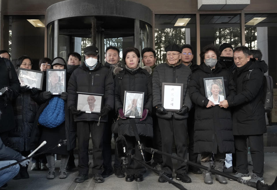 Family members of forced labor victims during the Japan's colonial period, speaks to the media at the Supreme Court in Seoul, South Korea, Thursday, Dec. 21, 2023. South Korea’s top court ordered two Japanese companies to financially compensate more of their wartime Korean workers for forced labor, as it sided Thursday with its contentious 2018 verdicts that caused a huge setback in relations between the two countries. (AP Photo/Ahn Young-joon)