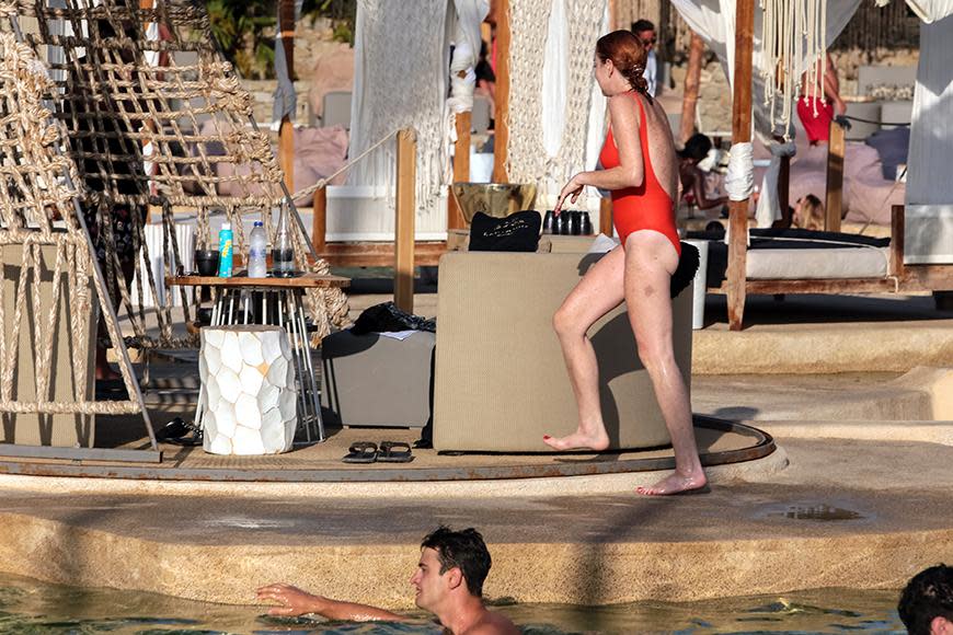 Lindsay Lohan soaks up the sun in a red swimsuit