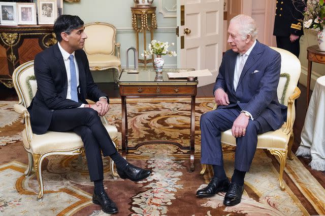 <p>JONATHAN BRADY/POOL/AFP via Getty</p> Prime Minister Rishi Sunak and King Charles talk at Buckingham Palace on February 21.