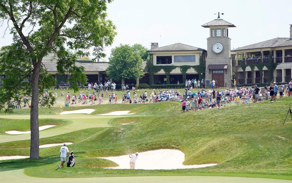 Russell Henley hits his second shot out of the bunker on the 18th hole Saturday at the Memorial.