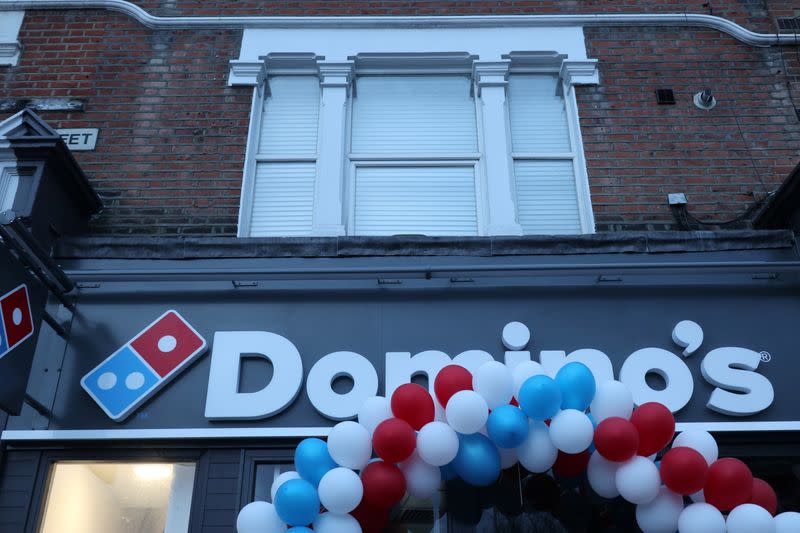 Balloons are seen on the front of a newly opened Domino's Pizza franchise in London, Britain