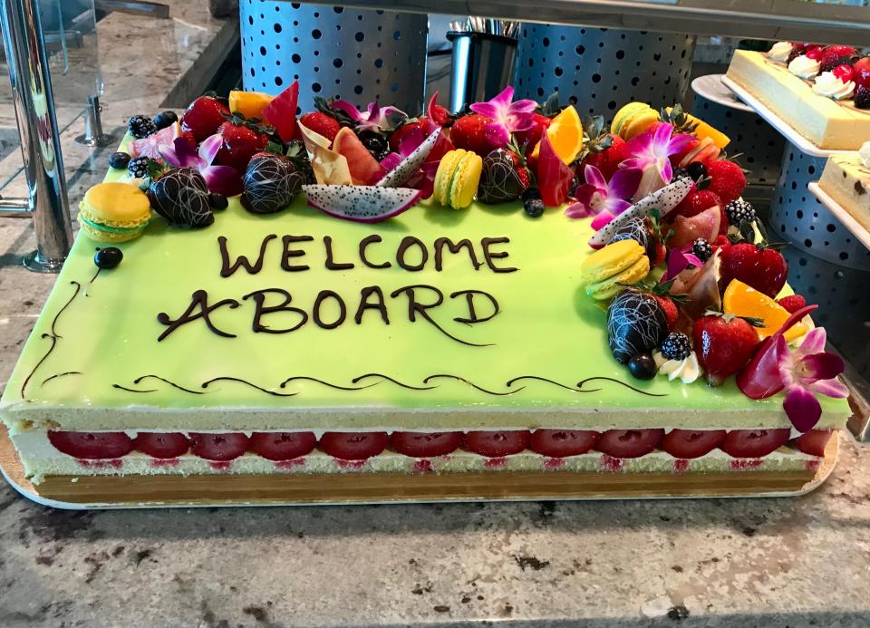 highly decorated cake on a cruise ship that says welcome aboard