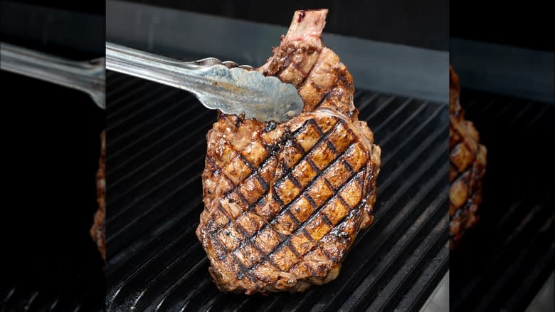 Chargrilled steak held with tongs