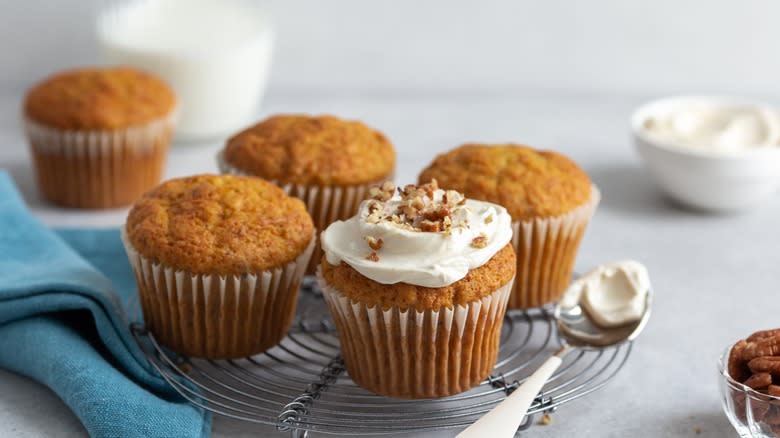 Carrot cake cupcakes, one with frosting