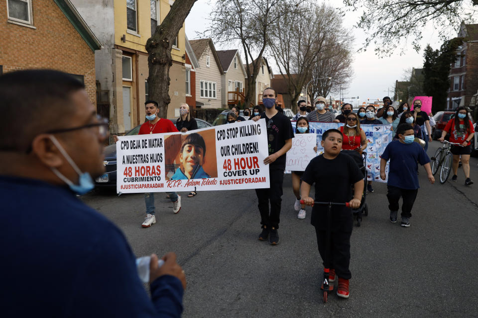 Members of Chicago's Little Village Community Council march on Tuesday, April 6, 2021 to protest against the death of 13-year-old Adam Toledo, who was shot by a Chicago Police officer at about 2 a.m. on March 29 in an alley west of the 2300 block of South Sawyer Avenue near Farragut Career Academy High School. (AP Photo/Shafkat Anowar)
