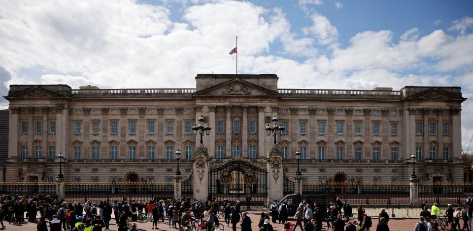 People gather outside Buckingham Palace where the Union Flag flies at half-mast in central London on April 9, 2021 after the announcement of the death of Britain's Prince Philip, Duke of Edinburgh. - Queen Elizabeth II's husband Prince Philip, who recently spent more than a month in hospital and underwent a heart procedure, died on April 9, 2021, Buckingham Palace announced. He was 99. (Photo by Tolga Akmen / AFP) (Photo by TOLGA AKMEN/AFP via Getty Images)