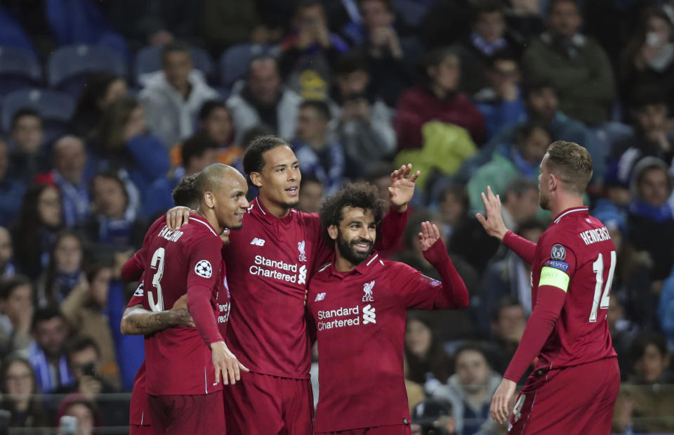 Liverpool's Virgil van Dijk celebrates with teammates after scoring his side's fourth goal during the Champions League quarterfinals, 2nd leg, soccer match between FC Porto and Liverpool at the Dragao stadium in Porto, Portugal, Wednesday, April 17, 2019. (AP Photo/Luis Vieira)