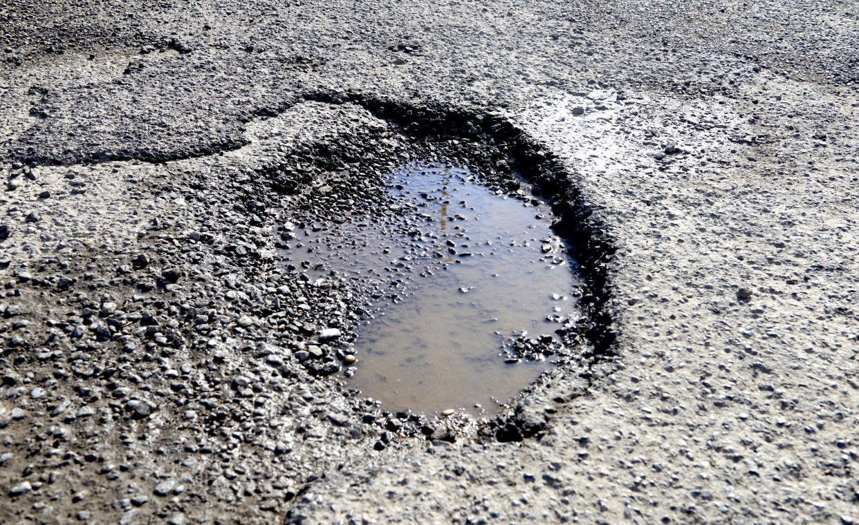 LONDON, ENGLAND - JUNE 10:A pothole filled with water in a road on June 10,2022 in London, England. (Photo by Peter Dazeley/Getty Images)