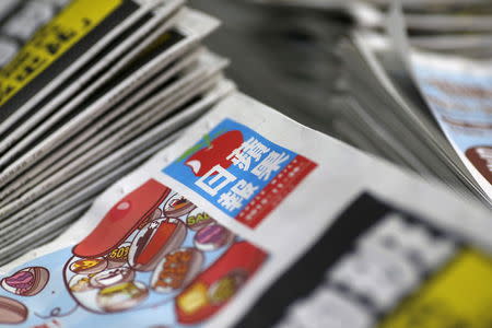 A copy of the Apple Daily newspaper, published by Next Media, are seen at the company's printing facility in Hong Kong, China November 26, 2015. REUTERS/Tyrone Siu