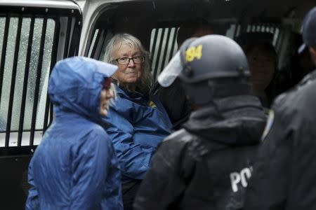 Demonstrators are detained after blocking doors to the Oakland Police Department to protest against killings of unarmed black men by police officers in Oakland, California December 15, 2014. REUTERS/Robert Galbraith