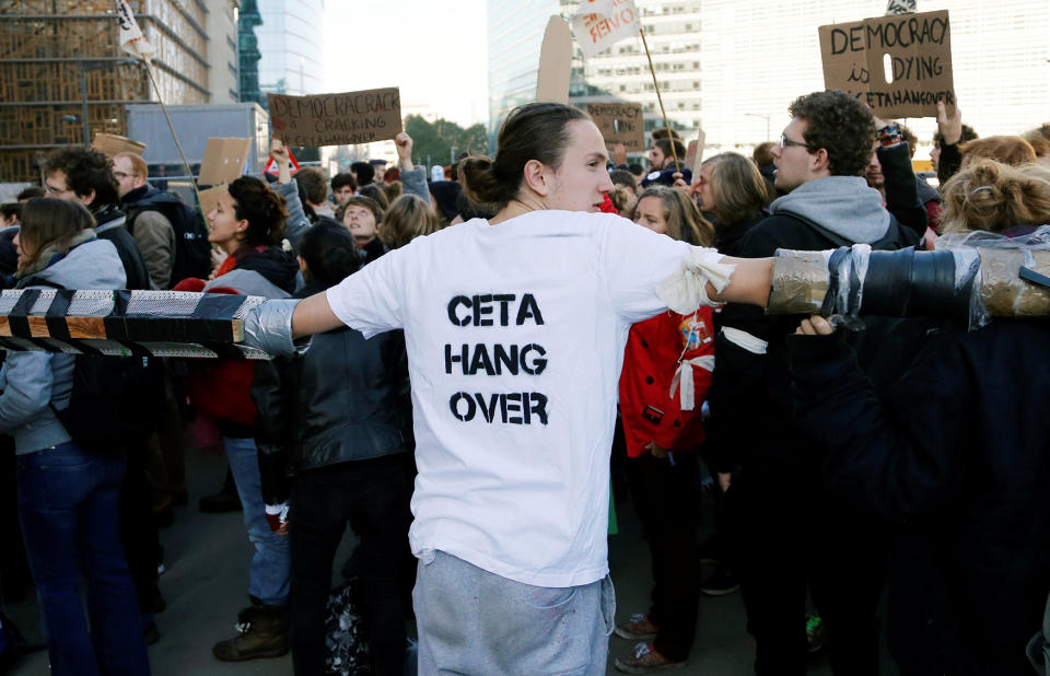 A demonstrator links his hands with fellow protesters in Brussels