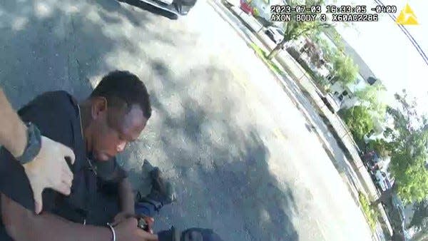 A screenshot from New Rochelle Police bodycam footage shows what police representatives say is Jarrell Garris' hands on an officer's holster