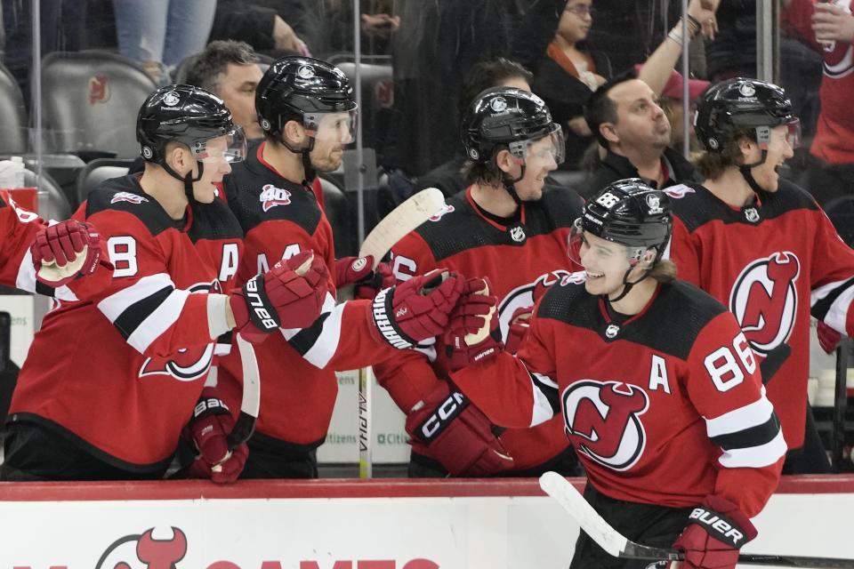 New Jersey Devils center Jack Hughes (86) is congratulated for his goal against the Columbus Blue Jackets during the first period of an NHL hockey game Thursday, April 6, 2023, in Newark, N.J. (AP Photo/Mary Altaffer)