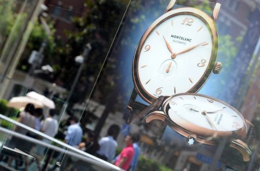 A window of a luxury watch shop is seen in Shanghai, on July 26. Fuelled by surging demand in China, luxury goods makers are bucking the global economic slowdown and reaping huge profits on sales of high-end handbags, expensive jewellery and posh perfumes