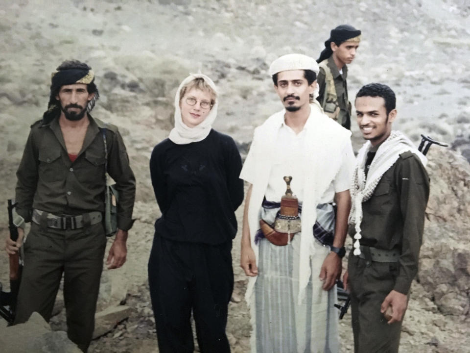 This 1994 photo provided by Katherine Roth shows her standing with Yemeni fighters. The photo was taken by Jamal Khashoggi in Yemen after the country’s civil war. Khashoggi was Roth’s friend and mentor when she was a young reporter on a fellowship studying Islamic movements. (Jamal Khashoggi/Courtesy of Katherine Roth via AP)