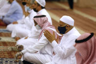 Worshippers wearing face masks to prevent the spread of COVID-19 prays at al-Mirabi Mosque in Jiddah, Saudi Arabia, Sunday, May 31, 2020. The Ministry of Islamic Affairs said mosques will open to the public for prayers from May 31 until June 20, except in Mecca, with precautionary measures and instructions. (AP Photo/Amr Nabil)