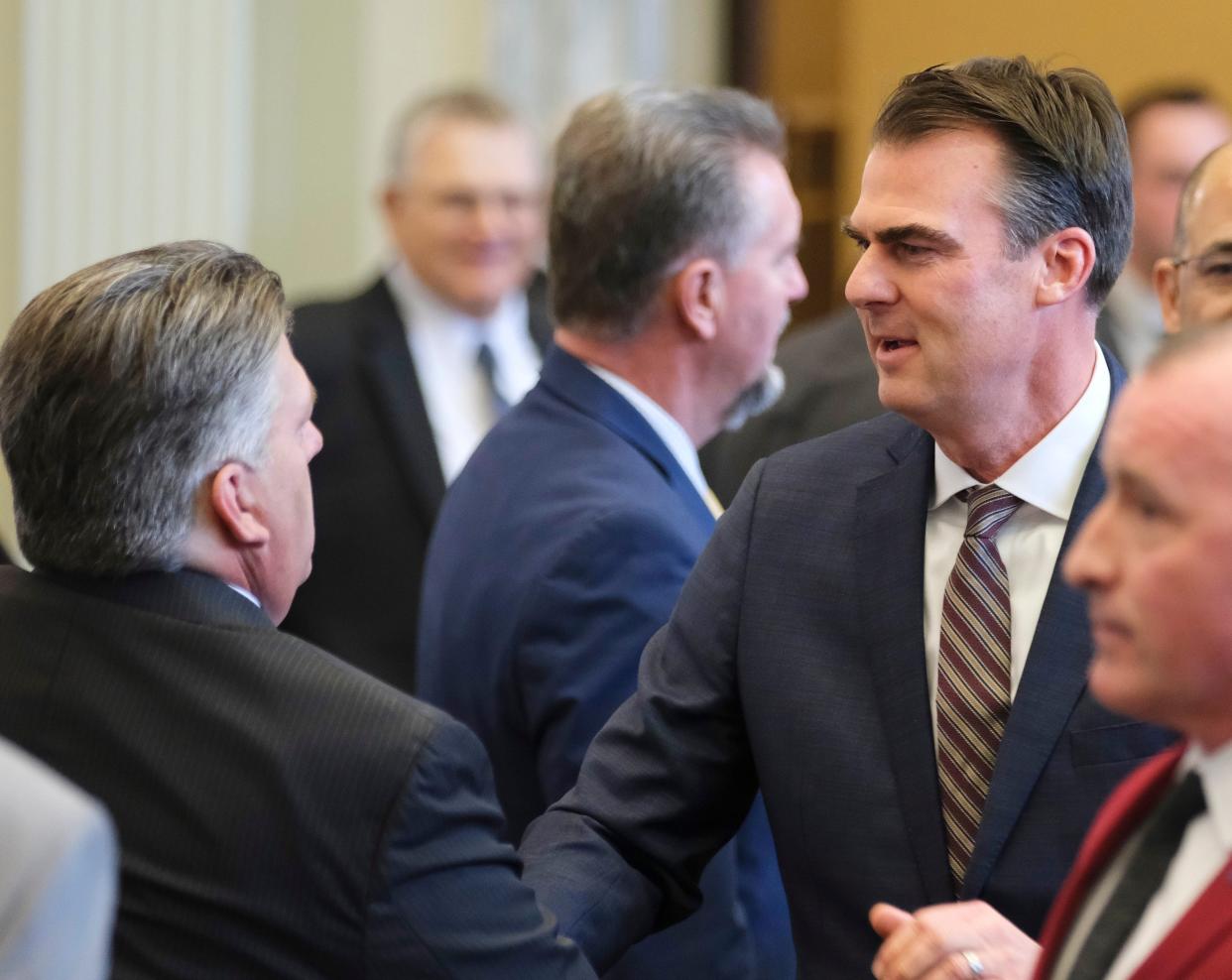 Gov. Kevin Stitt greets Rep. Scott Fetgatter as he arrives for his State of the State address to the joint session on the first day of the Oklahoma Legislature on Monday, Feb. 5, 2024.