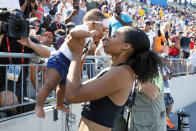 FILE - In this July 27, 2019, file photo, Allyson Felix holds her daughter Camryn after running the women's 400-meter dash final at the U.S. Championships athletics meet in Des Moines, Iowa. A rebellion led by some of the sport's top runners, Allyson Felix, Kara Goucher and Alysia Montano, is helping change that, and two months after the U.S. women's soccer players stated their case for equal pay, women in athletics are finding footing on an equally important crusade. "I feel like (my voice has been heard), and I feel like that only because of women coming together," Felix said in an interview with The Associated Press. (AP Photo/Charlie Neibergall, File)