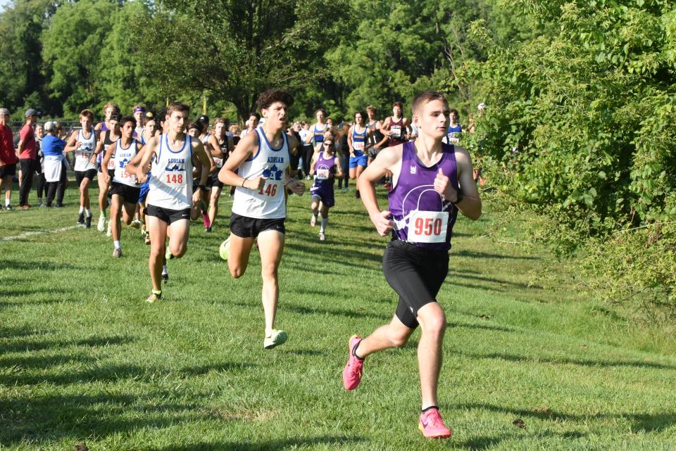 Onsted's Mitchell Hiatt leads Adrian's Jackson Nyack (back), Carter Fenner (middle) and Matthew Canales (front) during Saturday's Lenawee County Cross Country Preview at Tecumseh.