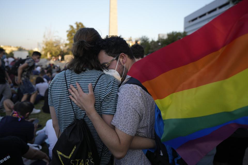 Members of the Movement for Homosexual Integration and Liberation celebrate after lawmakers approved legislation legalizing marriage and adoption by same-sex couples, in Santiago, Chile, Tuesday, Dec. 7, 2021. (AP Photo/Esteban Felix)