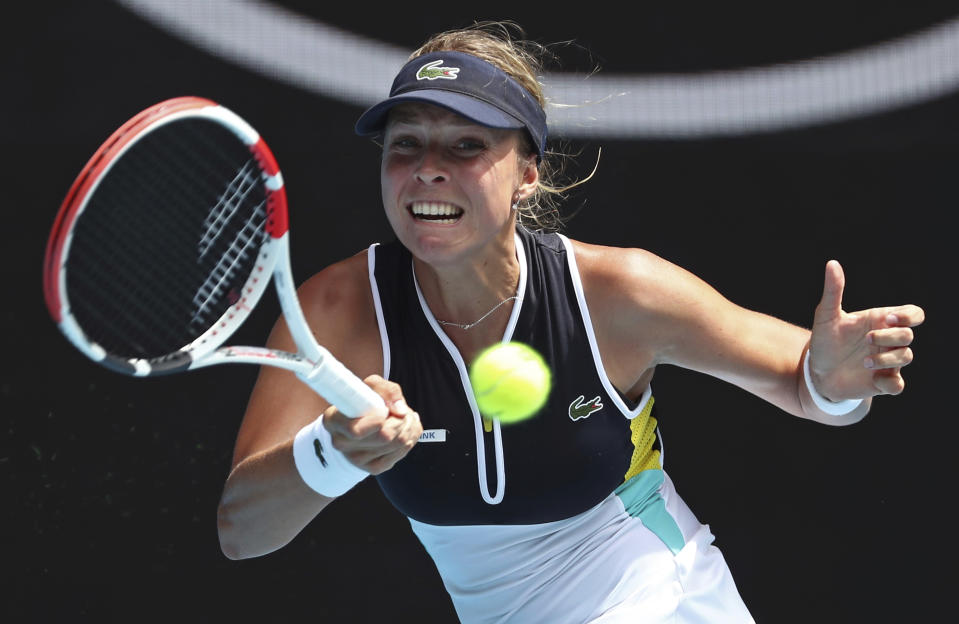 Estonia's Anett Kontaveit makes a forehand return to Poland's Iga Swiatek during their fourth round singles match at the Australian Open tennis championship in Melbourne, Australia, Monday, Jan. 27, 2020. (AP Photo/Dita Alangkara)