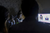 In this handout photo released by the Armenian Foreign Ministry on Monday, Sept. 28, 2020, people watch the State TV as they gather in a bomb shelter for protection against the shelling in Stepanakert, the self-proclaimed Republic of Nagorno-Karabakh, Azerbaijan. Nagorno-Karabakh authorities reported that shelling hit the region's capital of Stepanakert and the towns of Martakert and Martuni. Armenian Defense Ministry spokesman Artsrun Hovhannisyan also said Azerbaijani shelling hit within Armenian territory near the town of Vardenis. (Armenian Foreign Ministry via AP)
