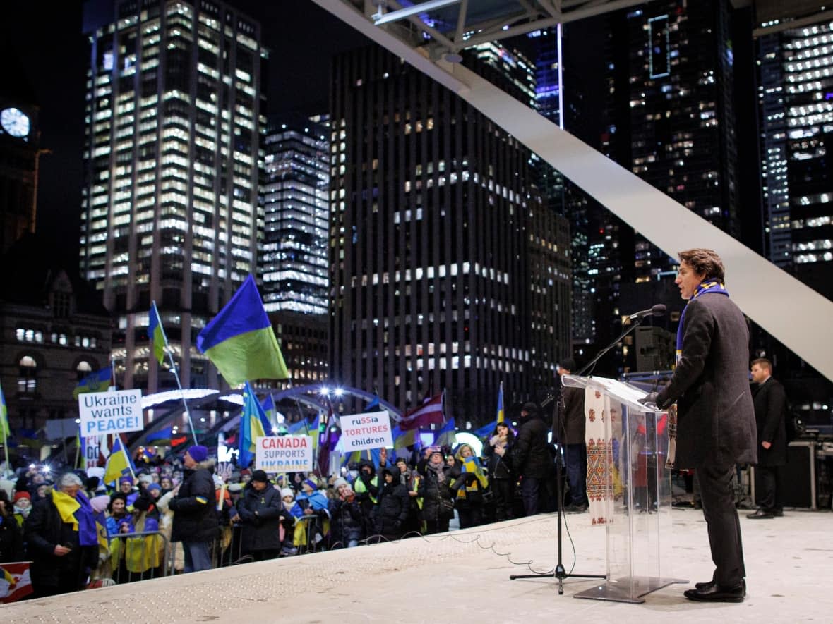 Members of Toronto’s Ukrainian community, joined by dignitaries including Prime Minister Justin Trudeau and Premier Doug Ford, take part in a rally at Nathan Phillips Square on Feb. 24, 2023 — a date marking one year since the Russian invasion of Ukraine began. (Evan Mitsui/CBC - image credit)