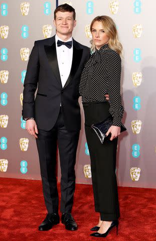 <p>Mike Marsland/WireImage</p> Ed Speleers and Asia Macey at the EE British Academy Film Awards