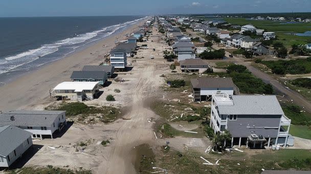PHOTO: Oak Island sustained wind and flood damage caused by Hurricane Isaias leaving the streets strewn with debris and covered with more than a foot of sand in areas close to the beach, Aug. 4, 2020, in North Carolina.  (Travis Long/The News & Observer via AP)