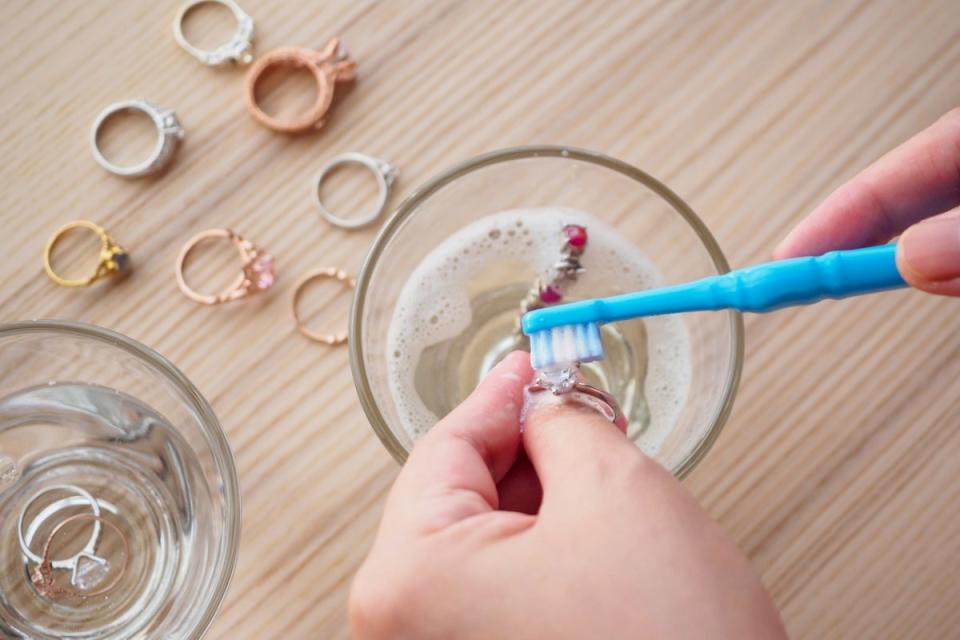 Cleaning jewelry with toothbrush