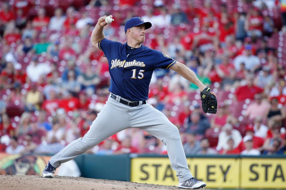 Brewers catcher Erik Kratz pitched in relief in the eighth inning against the Reds.