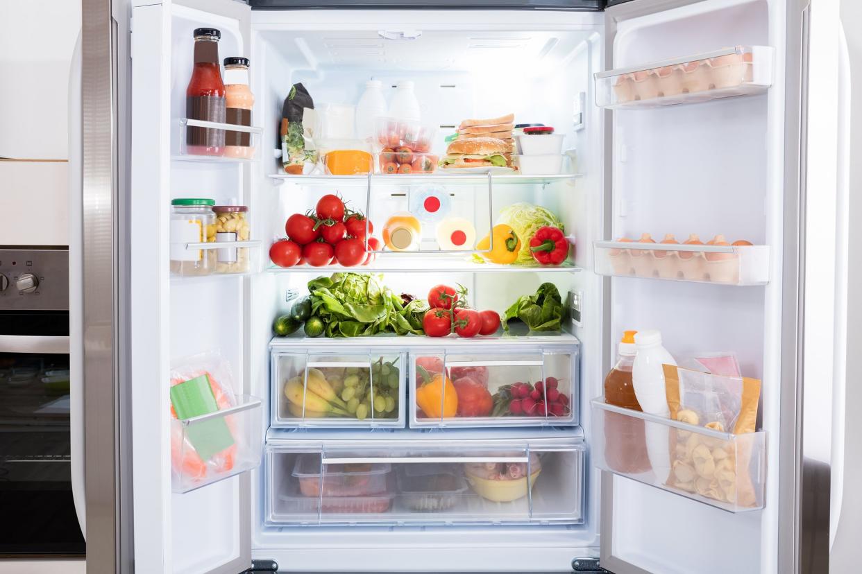 open refrigerator filled with fresh fruits and vegetable