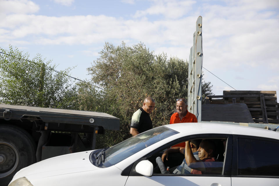 Locals gather near Palestinian fugitive Zakaria Zubeidi's hideouts in Umm al-Ghanam, northern Israel, Saturday, Sept. 11, 2021. Following Zubeidi's arrest, police said they have caught four of six Palestinians who broke out of a maximum-security prison early this week. (AP Photo/Ariel Schalit)