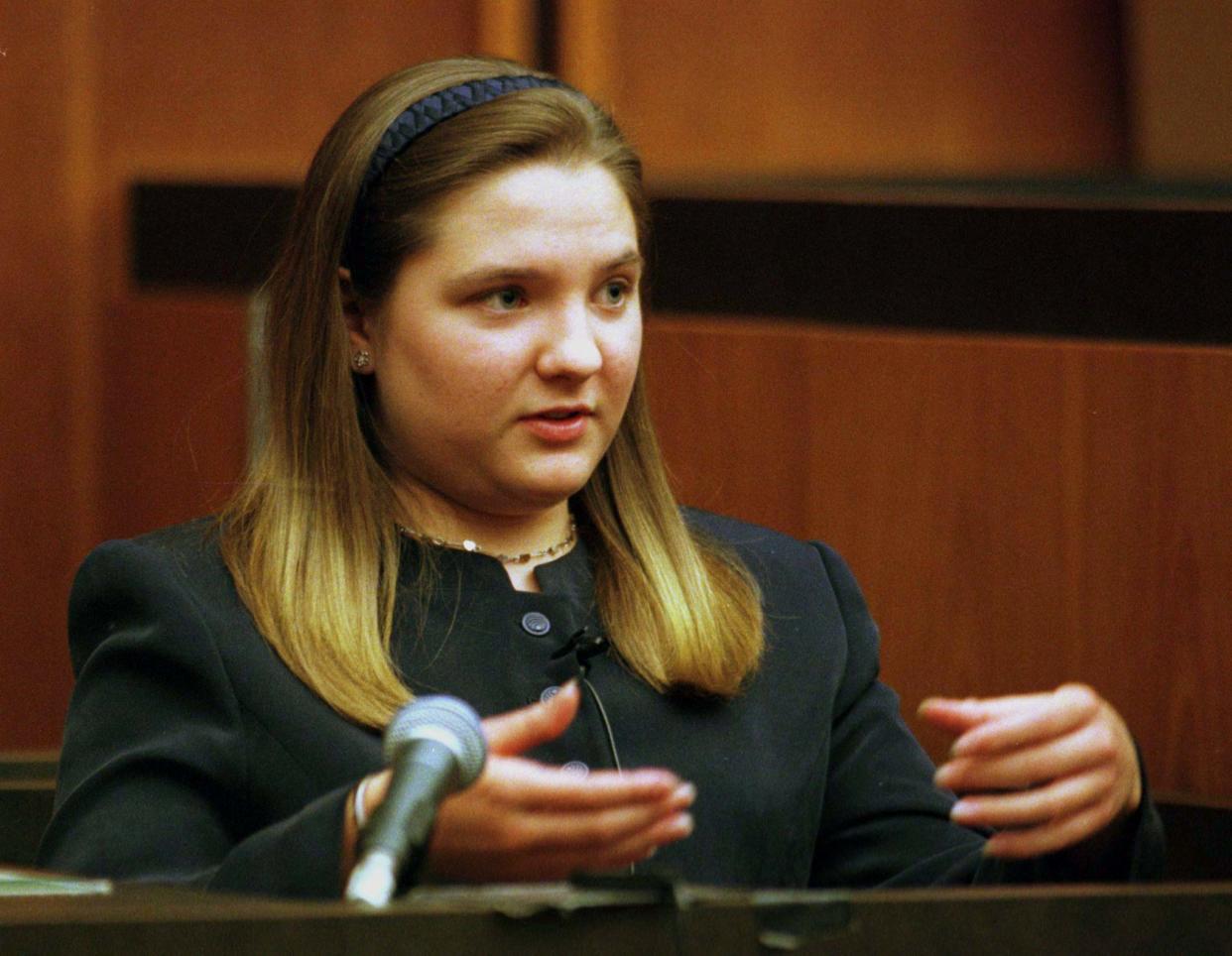 British nanny Louise Woodward demonstrates how she held Matthew Eappen the day he had to be rushed to the hospital as she testifies on her own behalf in her murder trial in a Cambridge, Massachusetts courtroom, October 23.  Woodward is accused of shaking nine month-old Matthew Eappen to death while he was in her care in February 1997.