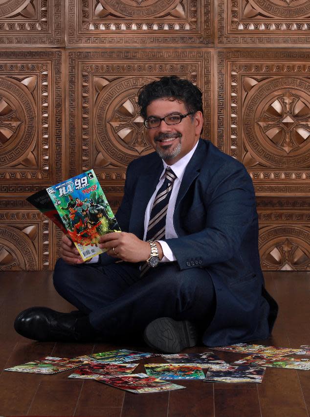 In this image released by Teshkeel Media Group, comic book author Naif Al-Mutawa holds up copies of his comic book series "The 99," on Long Island, N.Y. (AP Photo/Teshkeel Media Group, Cara Hromada Photography)